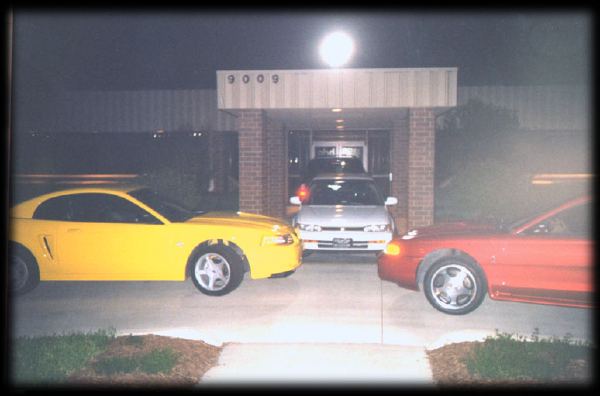 Brian, Matt, Tracy, and I with our cars parked in the walkway at work.